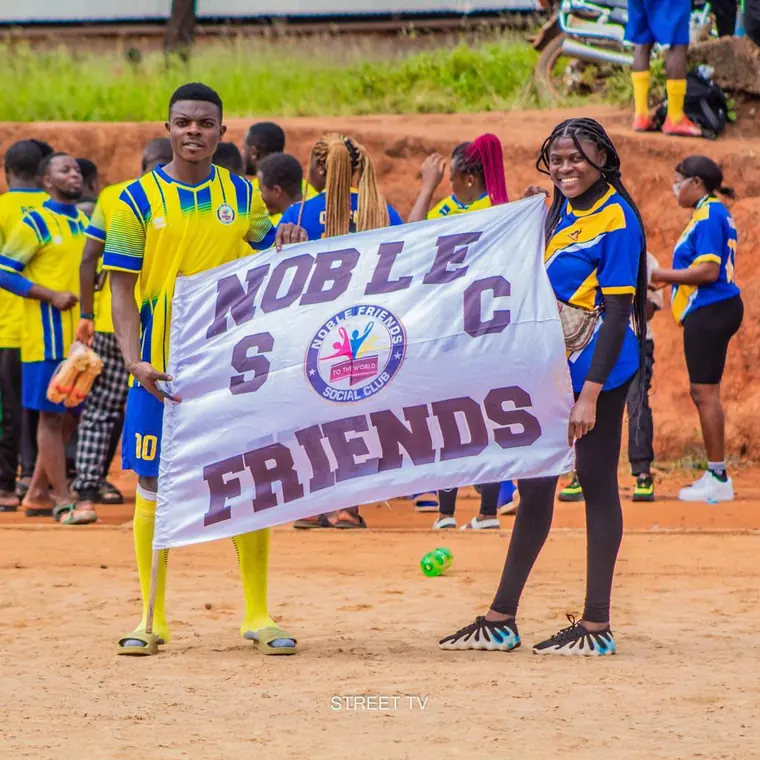 Members and supporters holding the Noble Friends banner