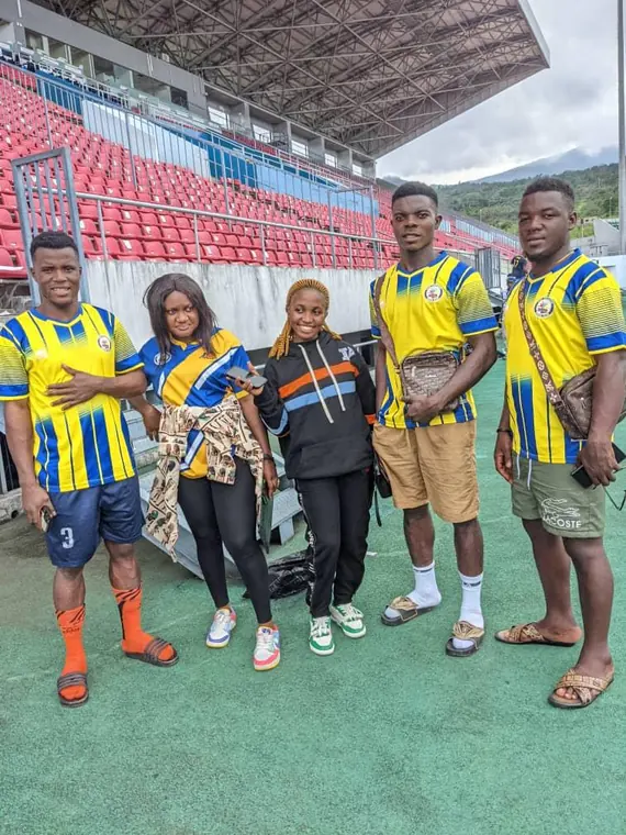 Four members posing together in club colours